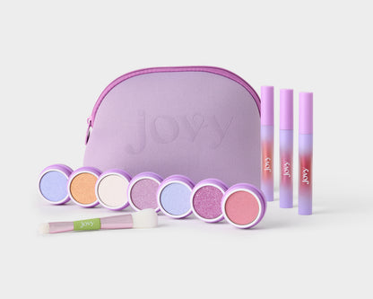 Jovy Glow Up Makeup set for tweens shows the lavender makeup bag, 3 lip glosses, 7 dual eyeshadow/blush colors, and a duo makeup brush.