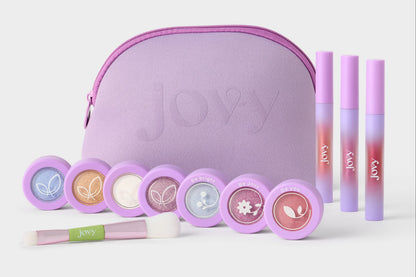 Jovy Glow Up Makeup set for tweens shows the lavender makeup bag, 3 lip glosses, 7 dual eyeshadow/blush colors, and a duo makeup brush.
